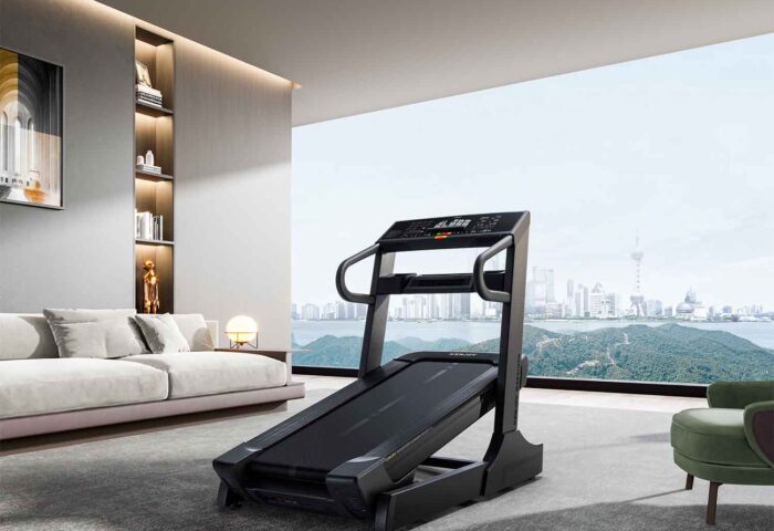 marathon treadmill in a living room setting with a large window overlooking a city